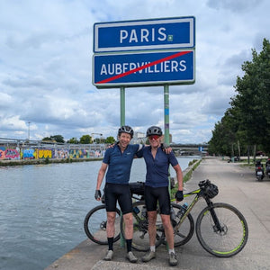 2 cyclists in front of the entrance sign to Paris, almost 400 kms away the from the start point in London.