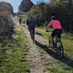 a Group of four gravel cyclists riding along a track towards Brighton with Hidden Tracks Cycling