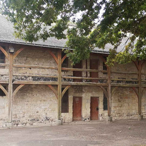 Typical French barn w with a wooden gallery as seen on Hidden Tracks Cycling's Trail of Two Cities Gravel bike ride from London to Paris