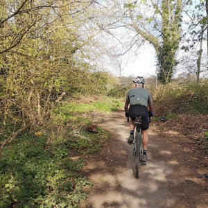 Single gravel rider on a trail in Spring time