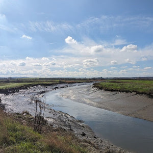 River estuary at low tide with large muddy banks on a bright spring day as found on the north Kent Marshes on a Hidden tracks Cycling Gravel ride