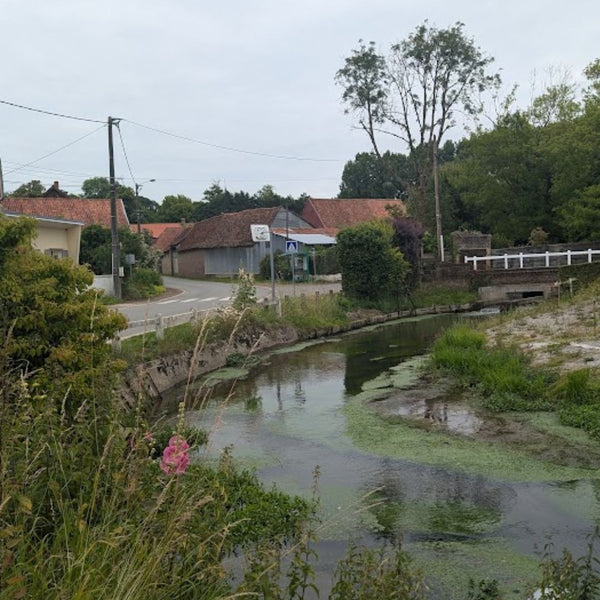 Small river running through a peaceful village in Picardy, on Hidden Tracks cycling's Landrace to Paris