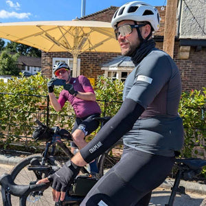 A pair of gravel riders taking photo's of each other on a sunny day