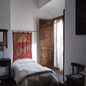 Simply furnished rustic hotel room, offering a comfortable and authentic stay during Hidden Tracks Cycling's Flamenco Gravel trip