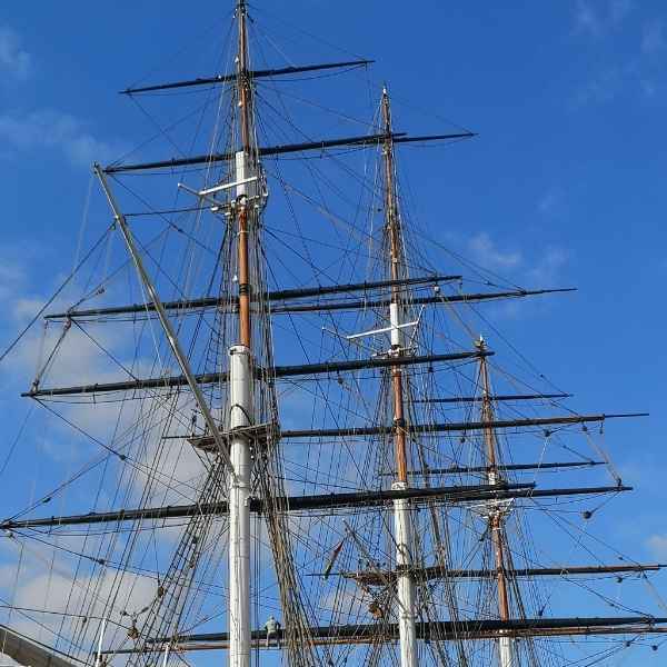 Masts of the Cutty Sark as seen from Tidal Explorer, a traffic-free  gpx bike route from Hidden Tracks Cycling