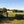 Load image into Gallery viewer, Solo cyclist riding on th4e margins of a bean field in Summer
