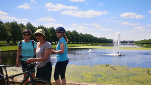 Group of women cyclist at the end of Long Water, Hampton Court. 