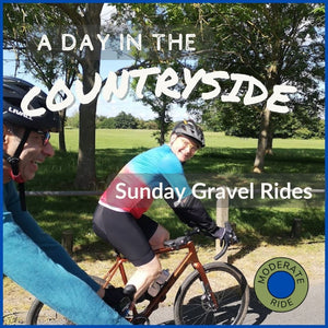 A scenic view of a Cotswold village with a church spire, inviting you to join a guided gravel bike ride.