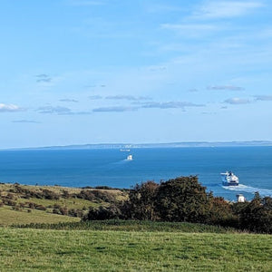 View of the Straights of Dover with ferries crossing to France, just before riders themselves catch a ferry to Calais on Hidden Tracks Cyclings adventure ride from London to Paris 