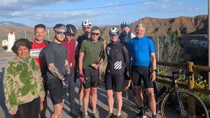 Group of Gravel cyclists posing  with a scenic background of the Gorafe Desert 