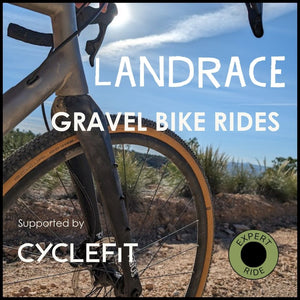 Picture of the front wheel of a gravel bike on a sandy track detailing Hidden Tracks Cycling's Landrace guided bike rides.