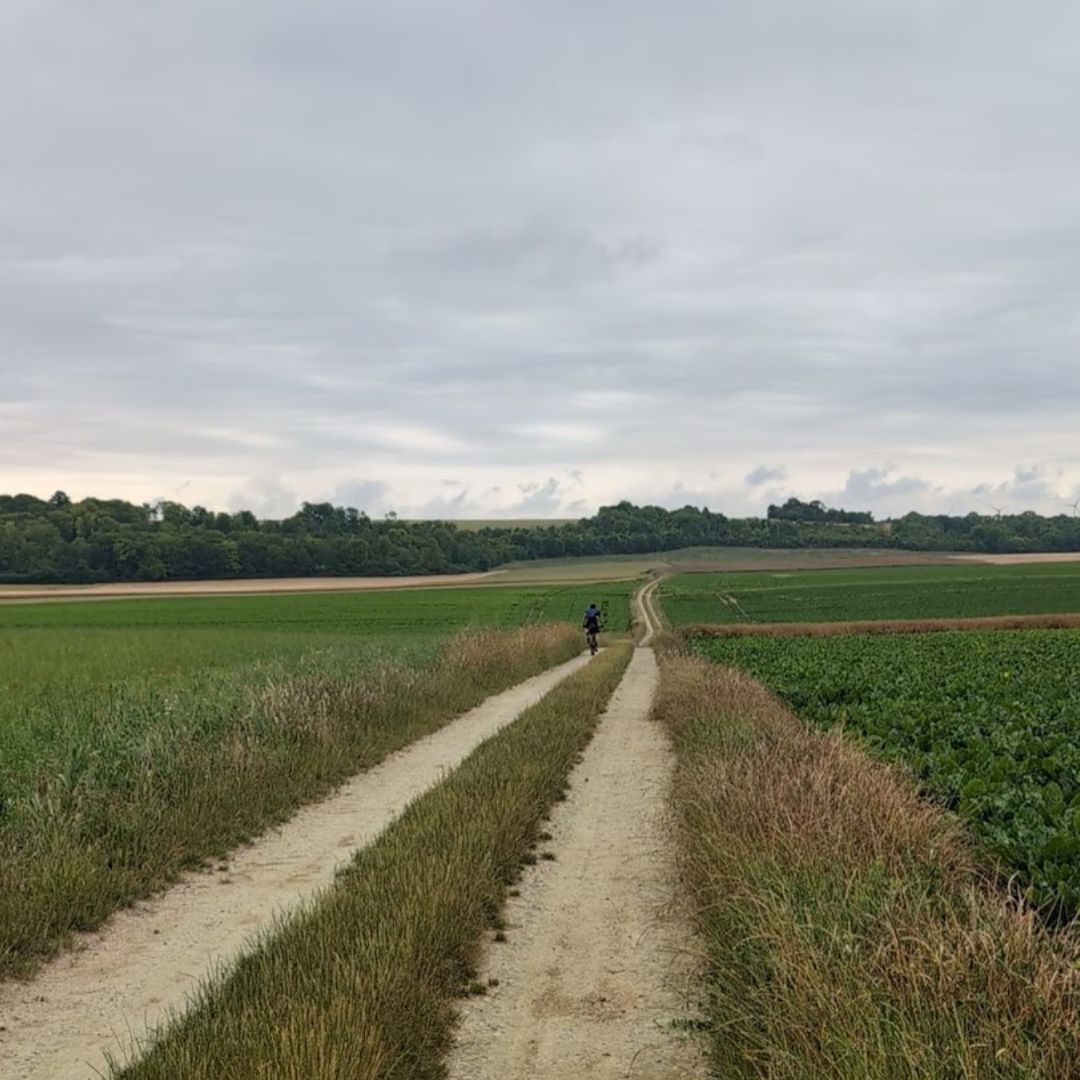 Long gravel road heading north through France on the L'Echappee Paris to London gravel ultra