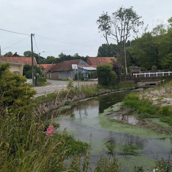 Small river running through a peaceful village in Picardy, on Hidden Tracks cycling's Landrace to Paris 