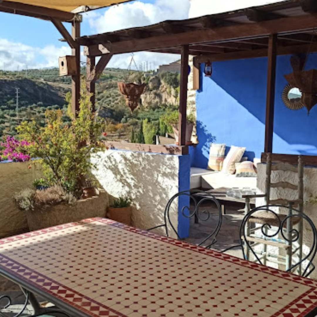 Terrace overlooking expansive olive groves, with stunning views of the surrounding landscape, part of a scenic cycling route on Hidden Tracks Cycling's Flamenco Gravel trip