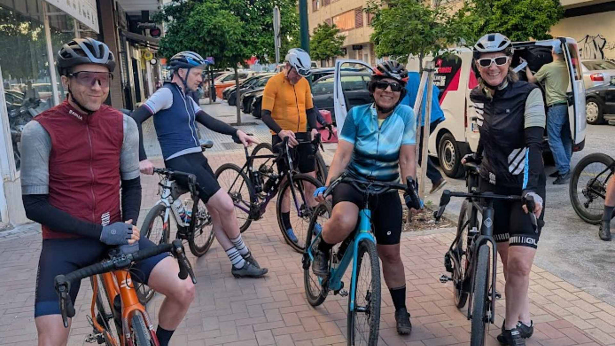Group of gravel cyclists with their bikes on a Malaga street