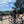 Load image into Gallery viewer, Bikepackers with loaded gravel bikes resting at a viewpoint bench overlooking the Weald on the Brighton Bound route.
