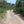 Load image into Gallery viewer, Gravel path between farmland and oak trees on the Brooklands GPX gravel bike route from London, Surrey.
