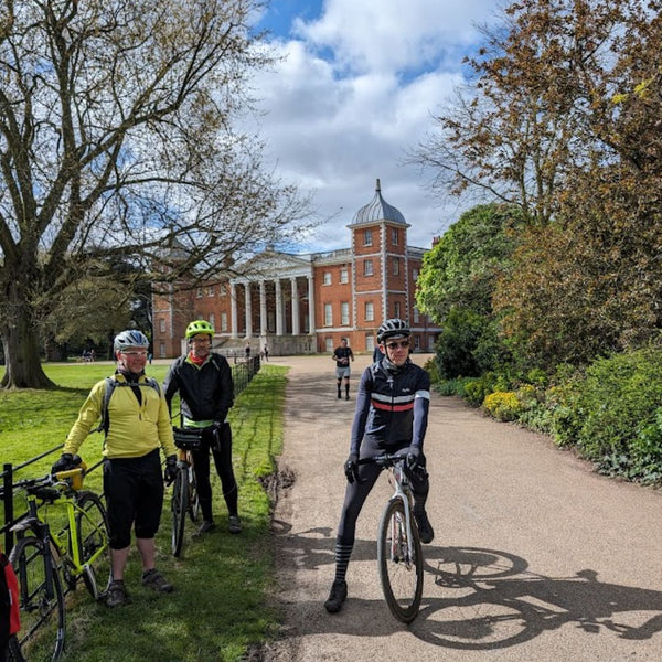 Cyclists pause with their bikes in front of Osterley House on this West London gravel bike route