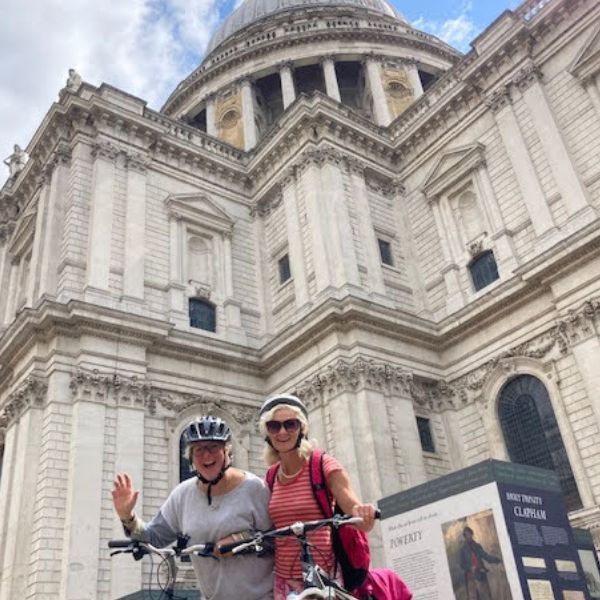 Two cyclists pause with their bikes outside St Paul's Cathedral on a bike ride through London