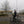 Load image into Gallery viewer, A cyclist beside the Heathrow perimeter road on this gravel bike route from London, with a plane parked just behind the fence
