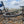 Load image into Gallery viewer, Bike resting on Brighton's pebble beach with the seafront terraces behind, at the finish of the No Hills to Brighton route.

