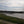 Load image into Gallery viewer, Long wooden pier crossing a tidal estuary on the No Hills to Brighton route, near Shoreham.
