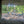Load image into Gallery viewer, Mountain Bikes resting at a trailside WW2 pillbox, framed through its concrete gunport, on the No Hills to Brighton route.
