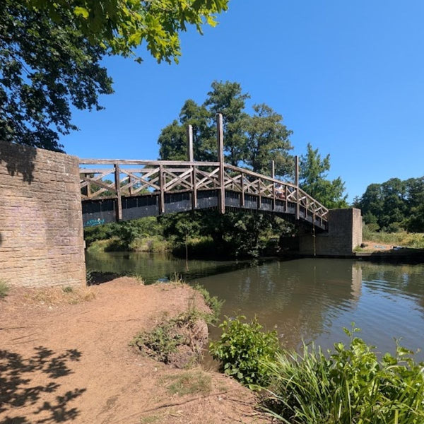 Wooden truss footbridge crossing the Wey Navigation on the No Hills to Brighton route.