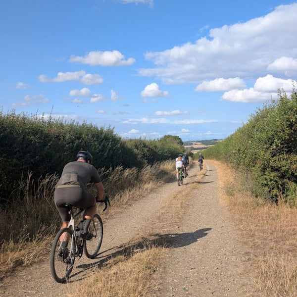 Riders spread out along a flint byway on the Oxfordian GPX gravel bike route from London to Oxford.