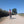 Load image into Gallery viewer, A rider on the Oxfordian GPX gravel bike route from London to Oxford, on a sunlit gravel lane through the Chiltern countryside.
