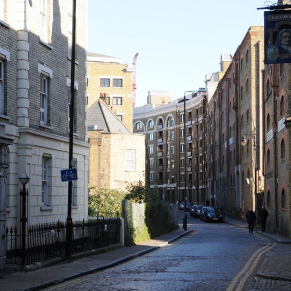 The cobbled streets of Wapping and the Captain Kidd pub sign, a characterful stretch of this London bike ride