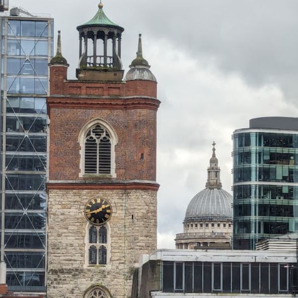 A Wren-designed church tower with the dome of St Paul's Cathedral behind it, spotted while discovering London by bike