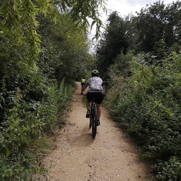 Mountain bikers riding on a bridlepath  near Epsom, Surrey on Hidden Tracks Cycling’s Roman road to Box Hill bike route.