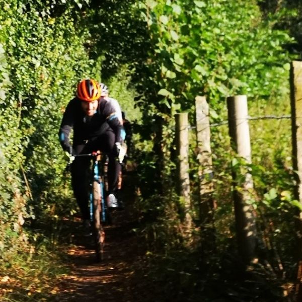 Single cyclist riding on the Tillingbourne Trails  on Hidden Tracks Cycling’s gravel bike route exploring the Tillingbourne Valley in Surrey 
