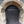 Load image into Gallery viewer, Arched shape ancient black wooden door t with ‘Commit no nuisance ‘ written on it in white paint as seen on Hidden Tracks Cycling’s Pilgrimage to St Albans Gravel bike route
