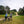 Load image into Gallery viewer, Two riders pause with their bikes on the open grassland of Mitcham Common on the Ophelia in the Hogs Mill route.
