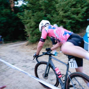 Women cyclist completing a running remount at a the MAAPSummercross race in Summer 2022 